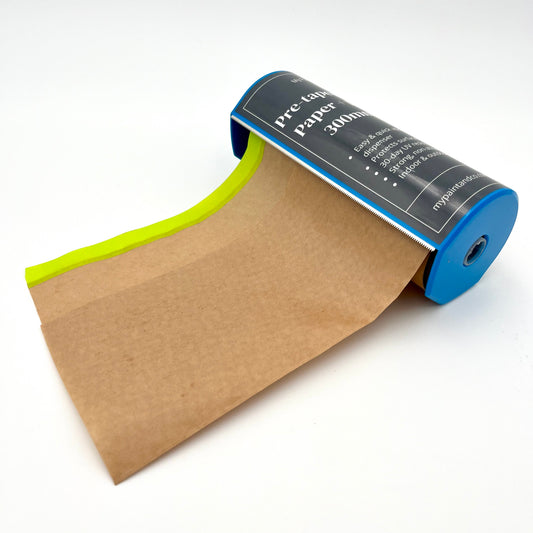 A roll of pre-taped masking paper with a dispenser, partially unrolled to show the brown paper and green painter's tape.