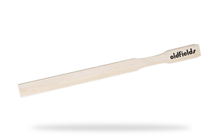 White tongue scraper with 'oldfields' branding on a transparent background